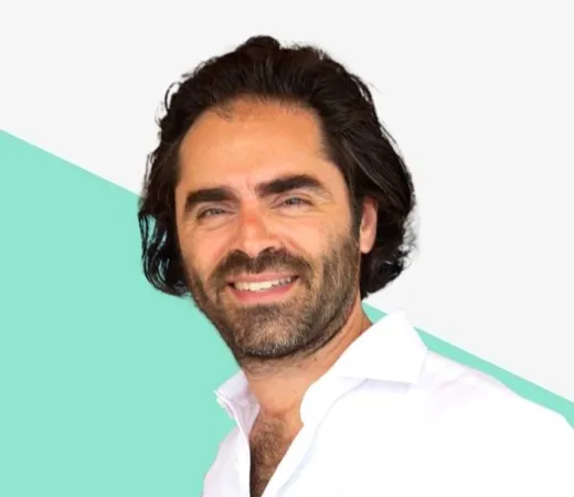 Smiling man with dark hair in a white shirt