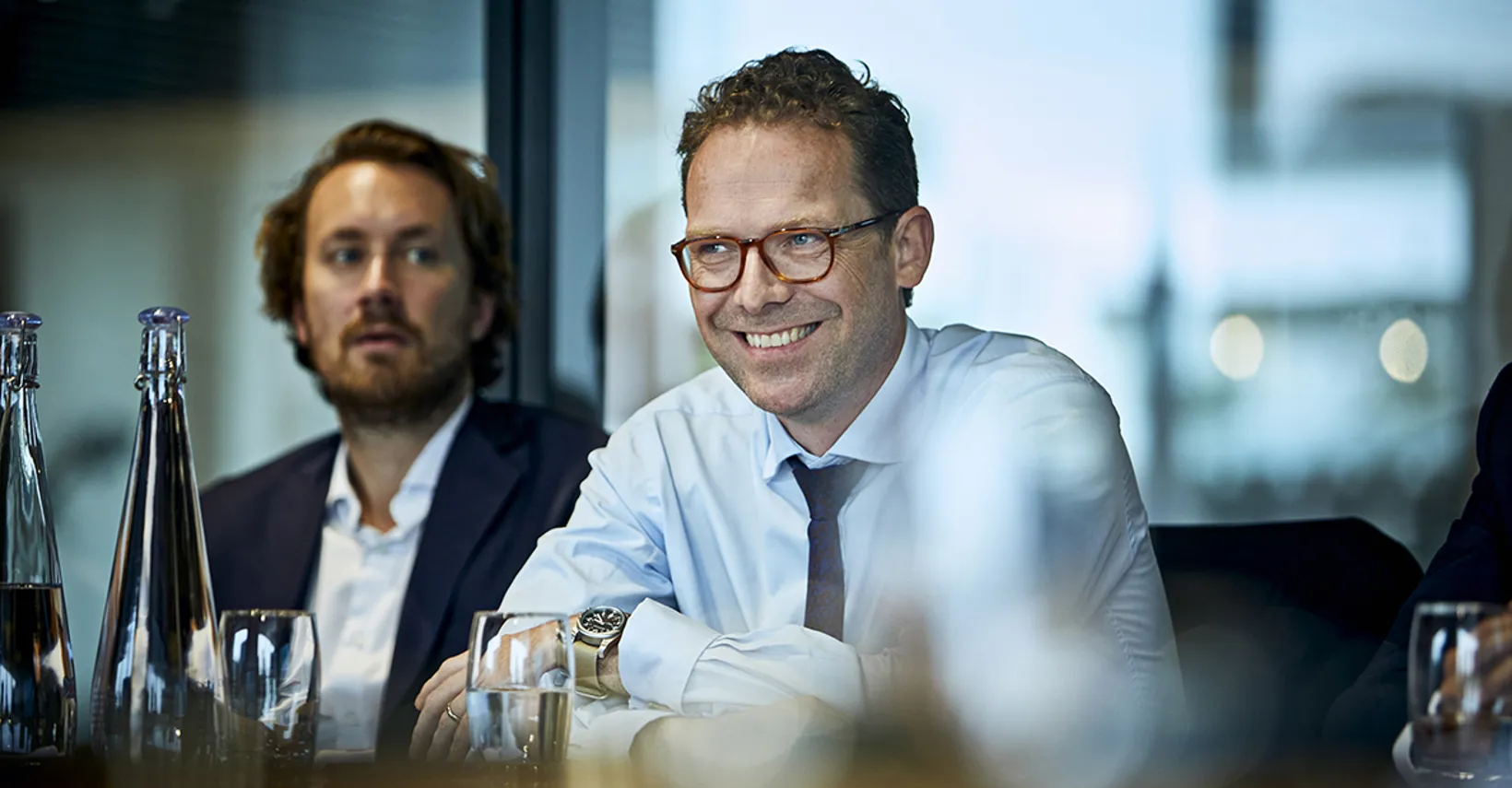 focus on a man smiling in a meeting