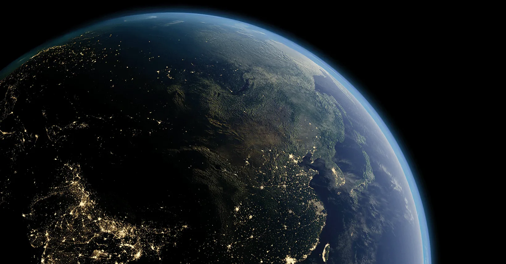 Earth from space showing curvature, land/water mix, and illuminated areas over Asia.