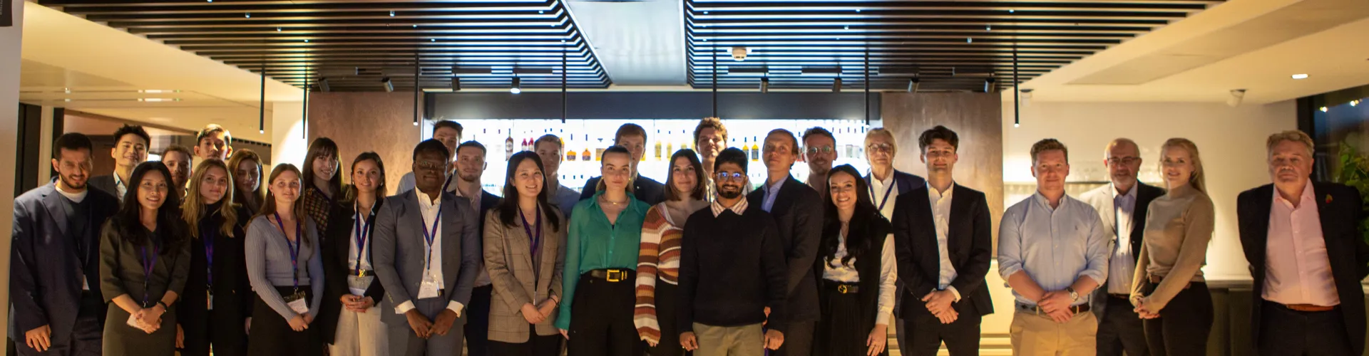 Group photo of people in a modern interior.