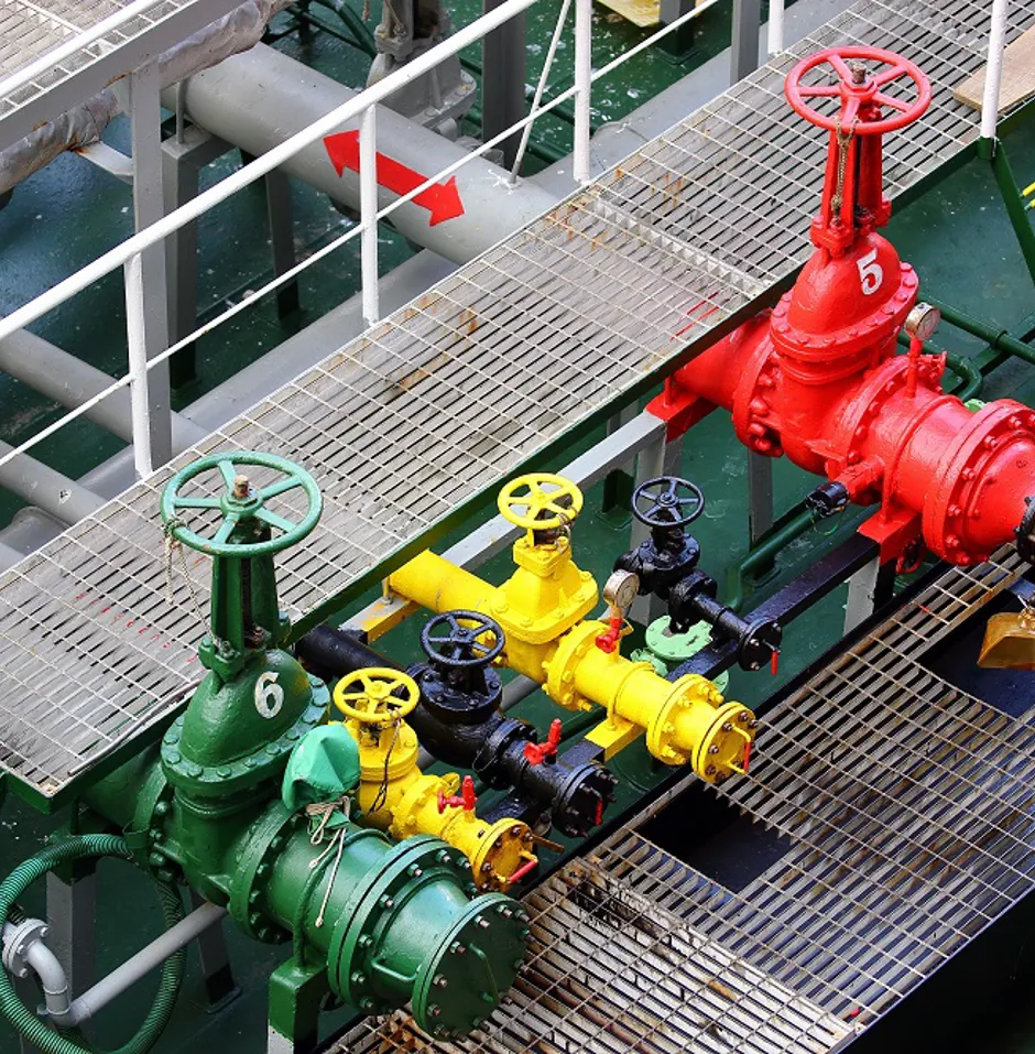 Colorful industrial valves on a metal platform.