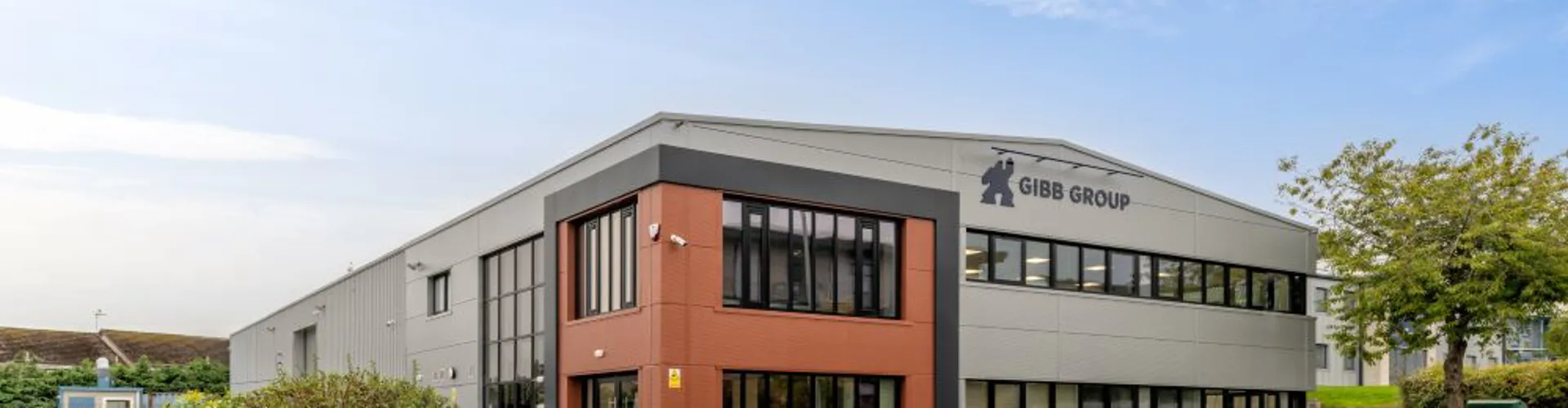 Modern gray building with Gibb Group signage.