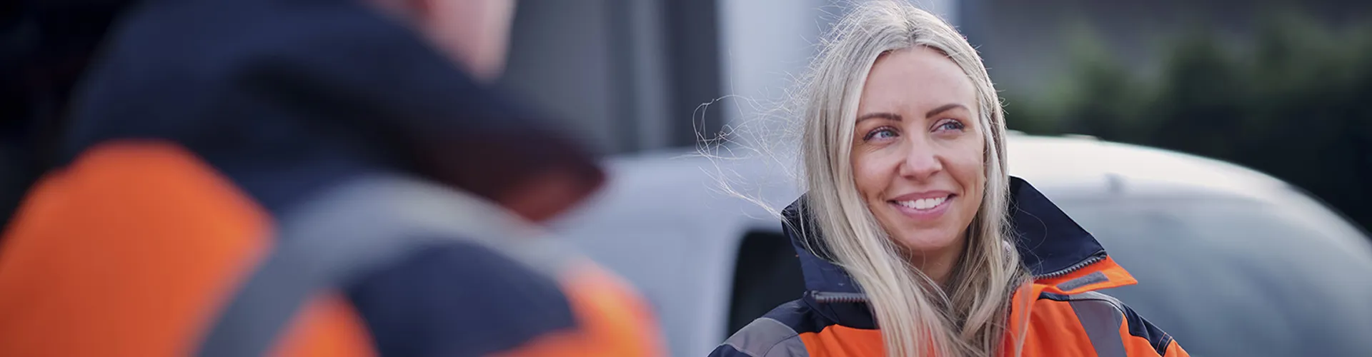 quayside employees smiling in high vis jacket