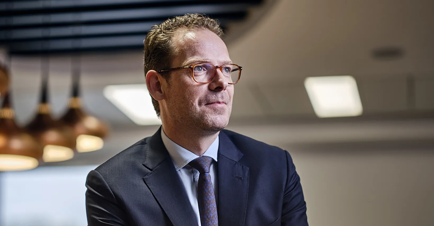 Duncan Lyall, head of carbon credit broking gesturing to others in a board room