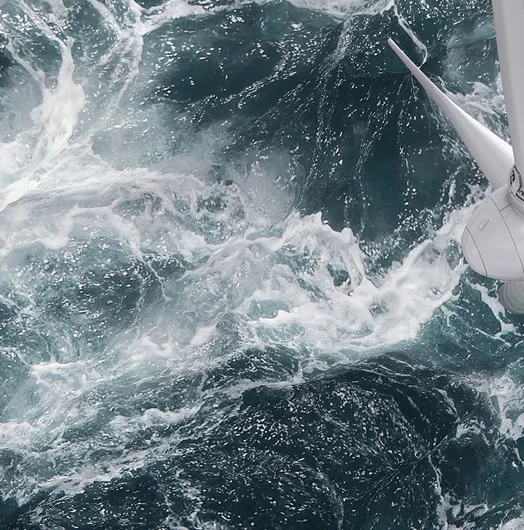 Aerial panorama of a close up wind turbine in the sea