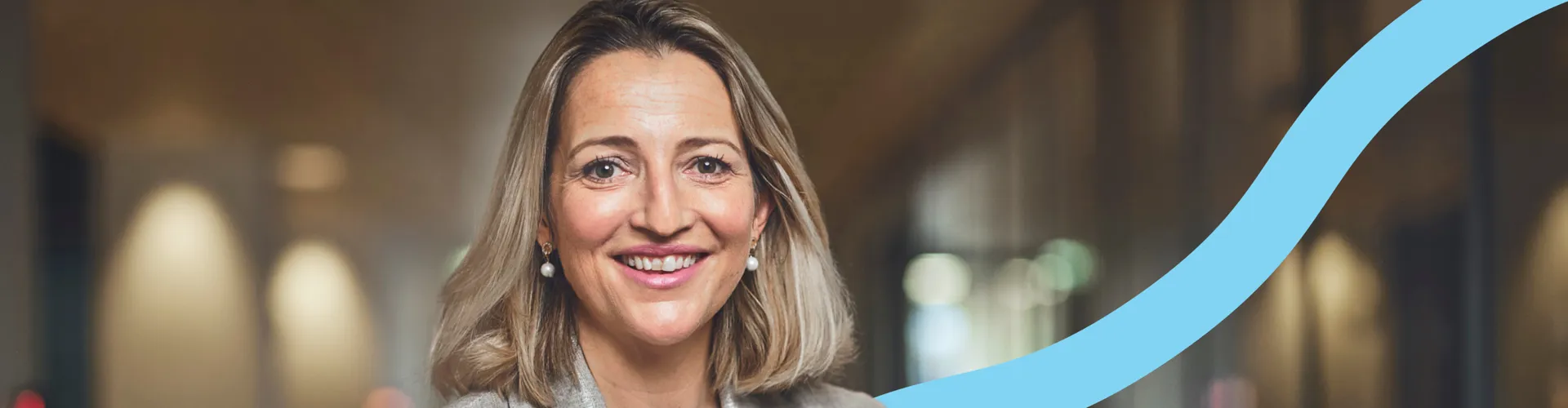 woman smiling, blue graphic background