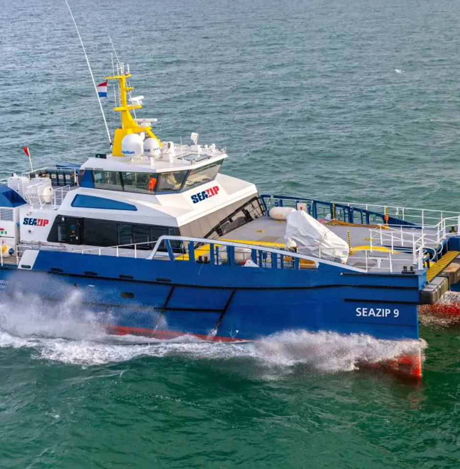 A blue and white vessel named "SEAZIP 9" at sea.