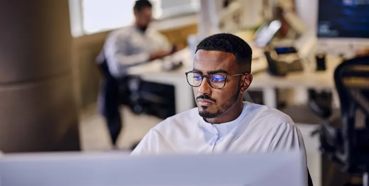 man sitting at computer