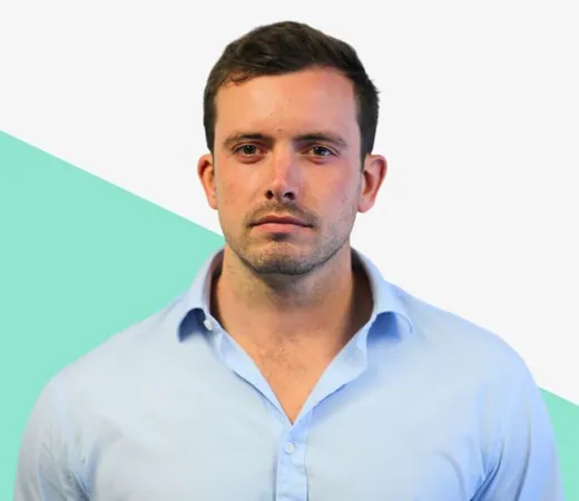 Man in light blue shirt with a serious expression.