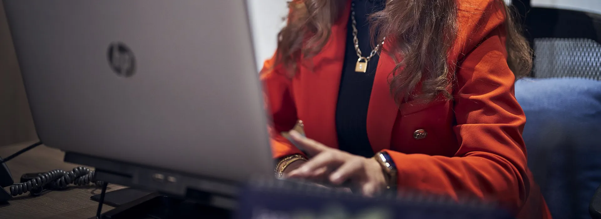 woman sitting down and working on her laptop