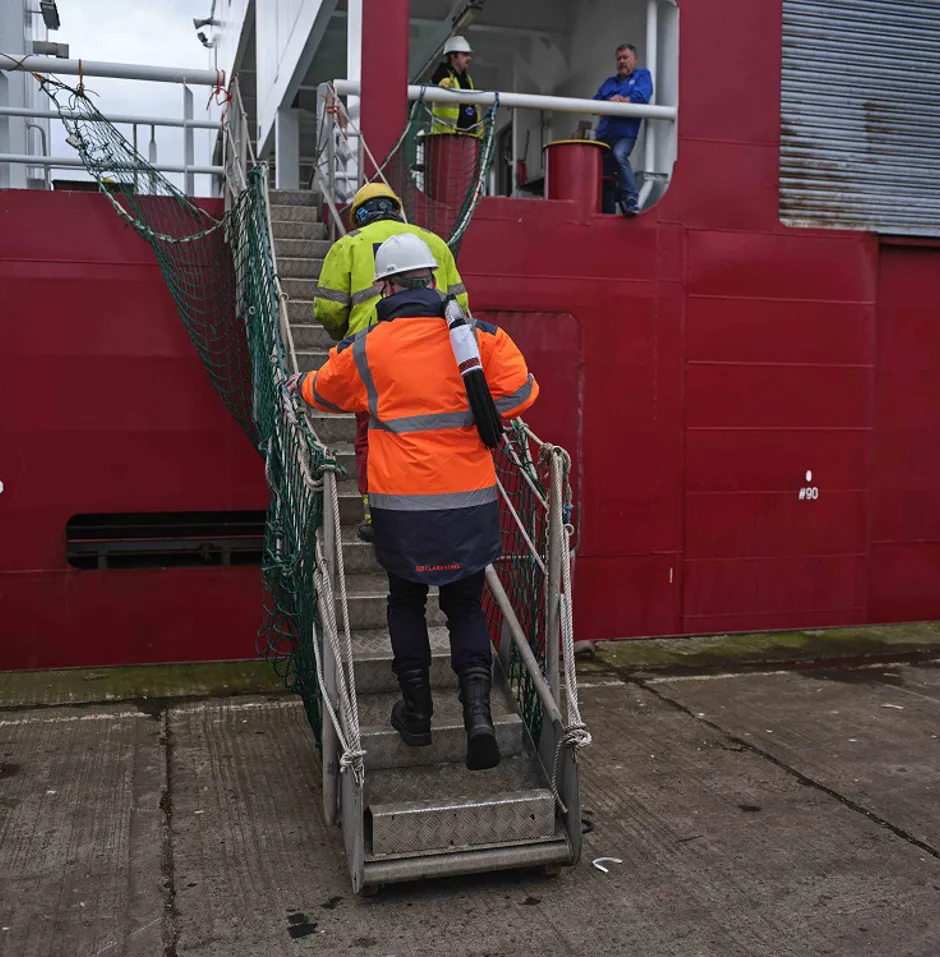 Man in uniform and helmet walking up stairs