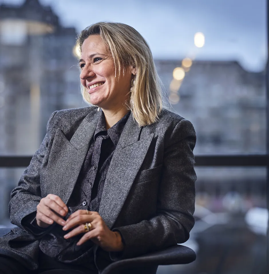 DOEL employee sitting at table talking and smiling