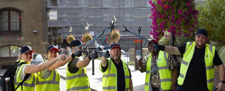 DOEL employees team picking up litter form dock