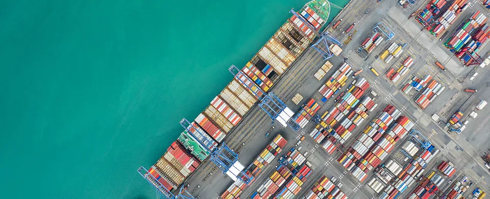 Aerial top view container cargo ship working. Business import export logistic and transportation of International by ship in the open sea.