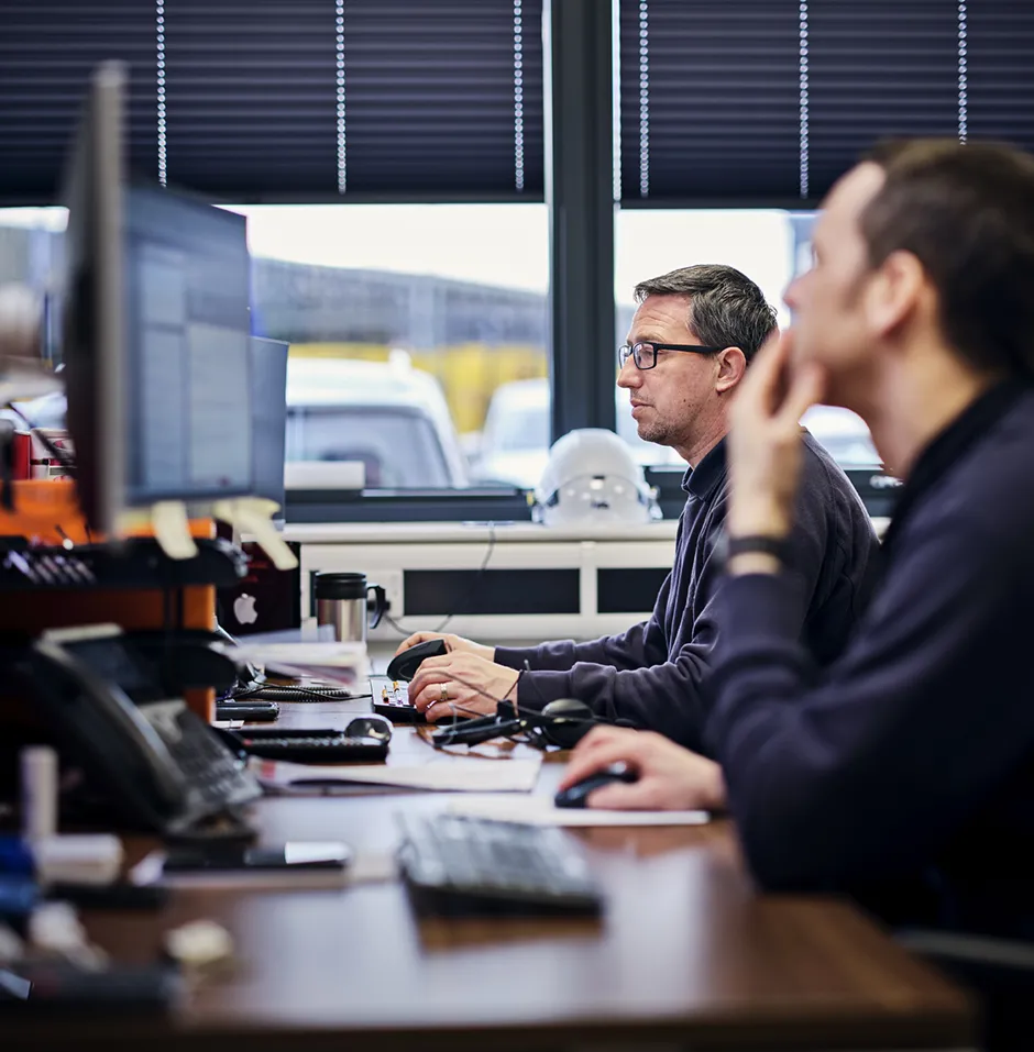 Freight operator at work looking at his computer screen