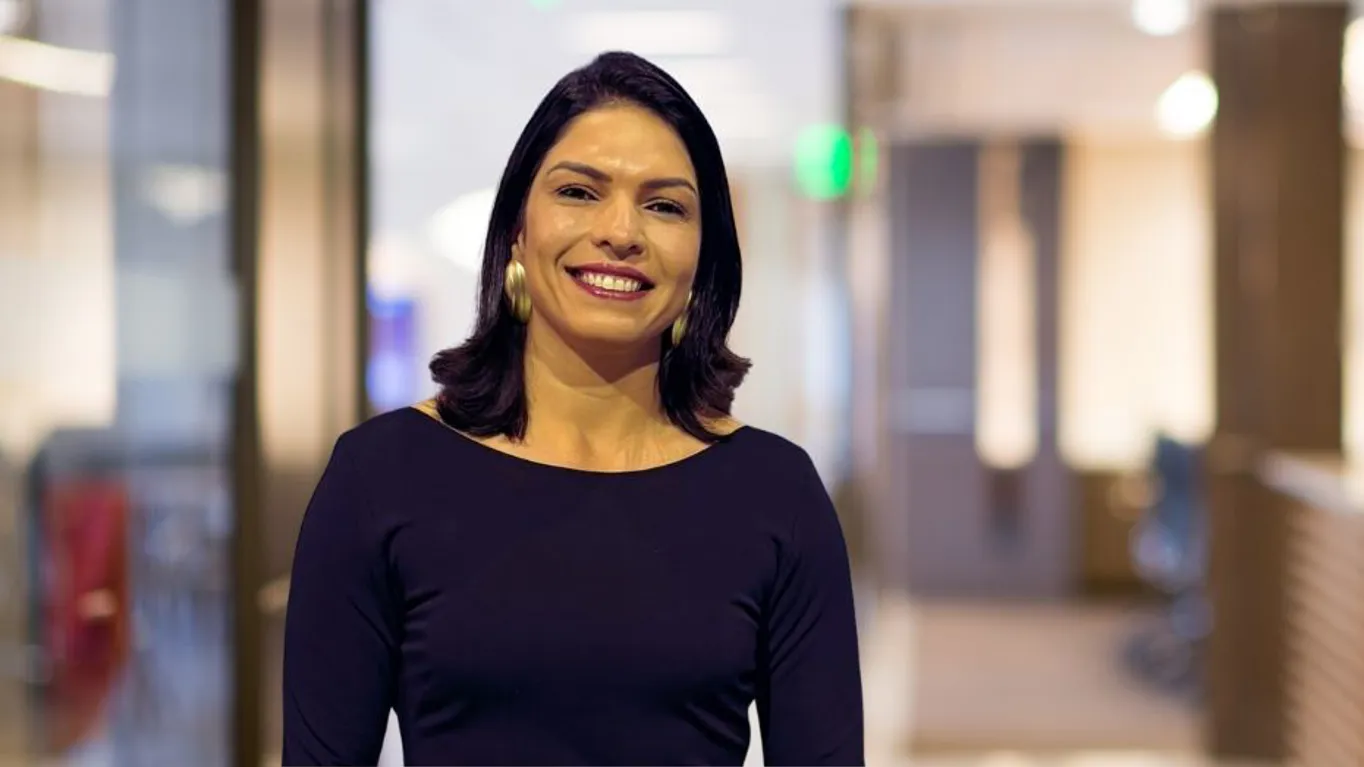 Smiling woman in a professional office setting.