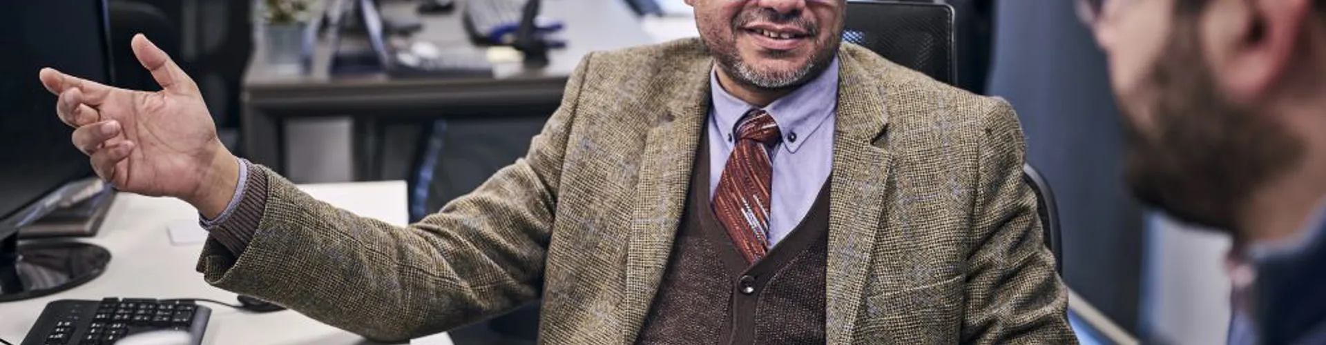 Close up of a man explaining something to a colleague