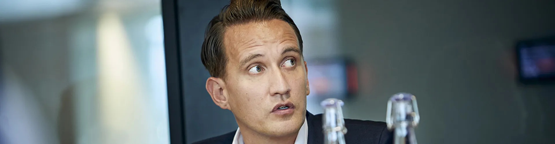 close up of a broker in a meeting looking forward