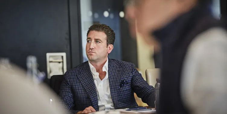man sitting in meeting listening