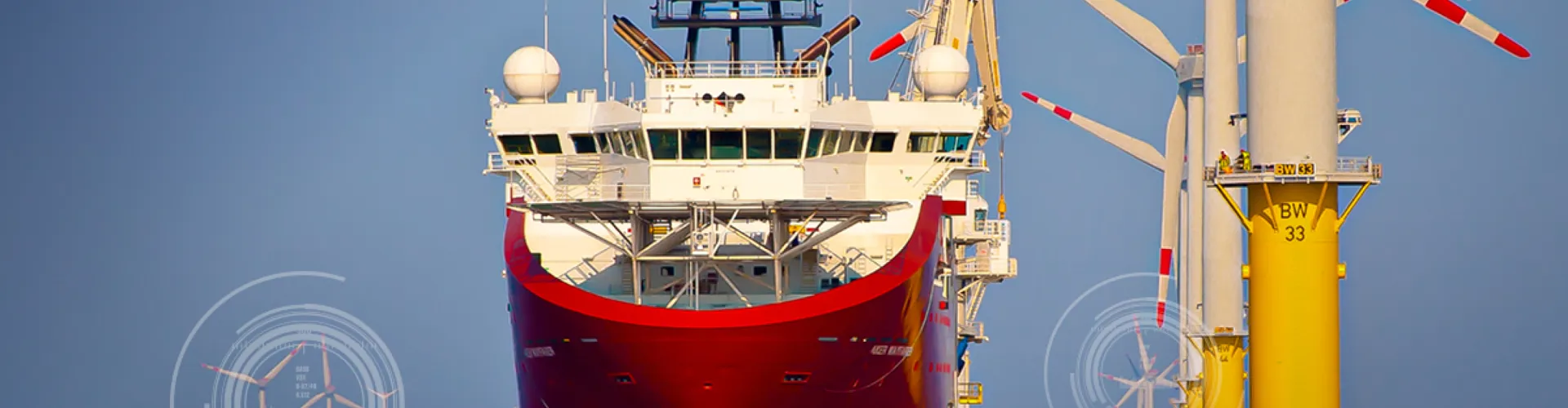 Red ship near offshore wind turbines.