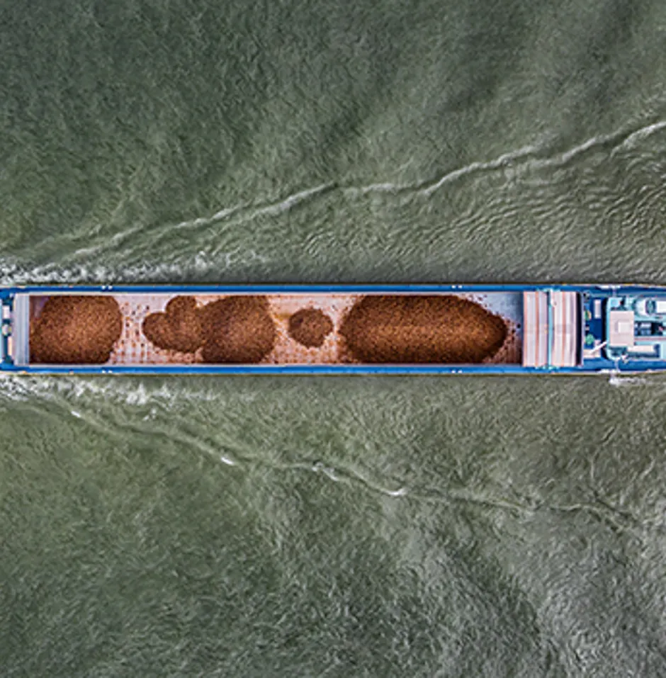 Cargo container ship at sea, top down Aerial view, freight business with beautiful wave pattern for logistics, import export, shipping or transportation