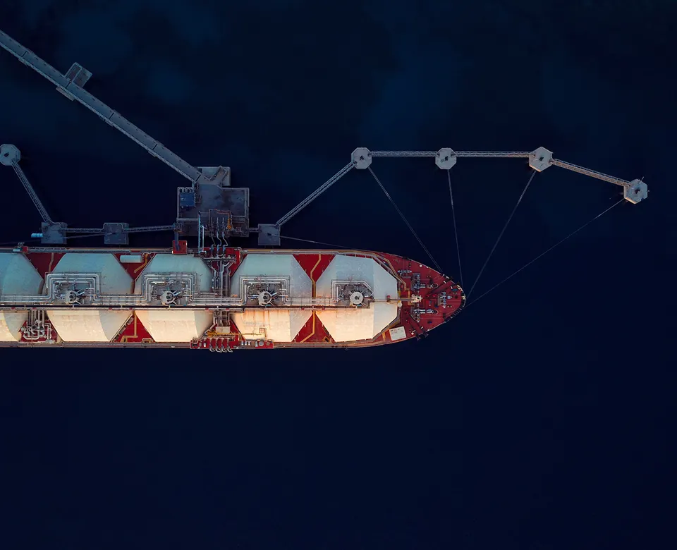 Aerial Top View Of A Liquefied Natural Gas (LNG) Tanker Moored To The Jetty