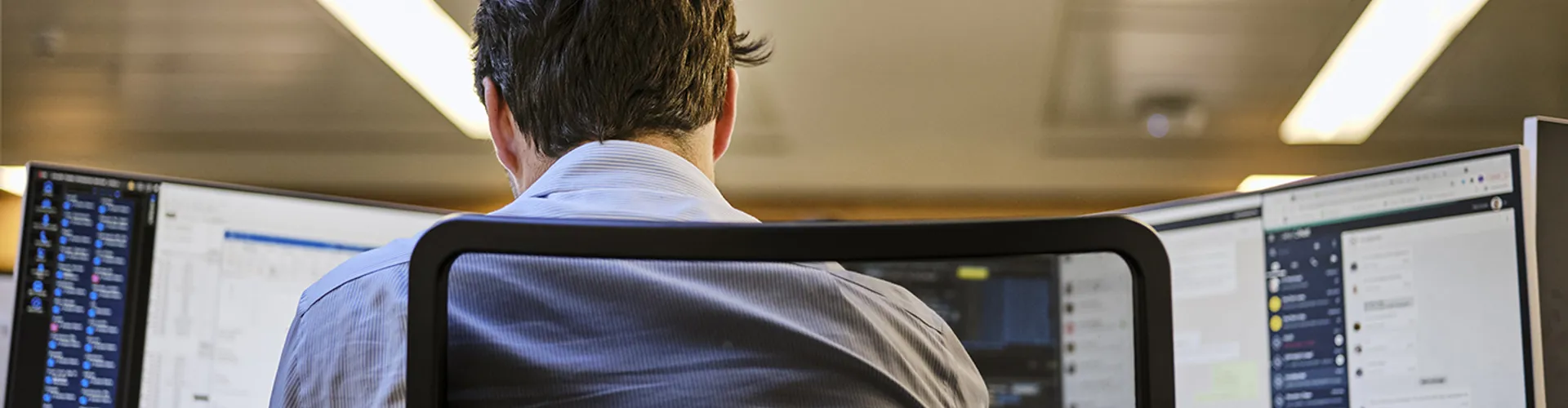 close up of a man looking at his computer screens